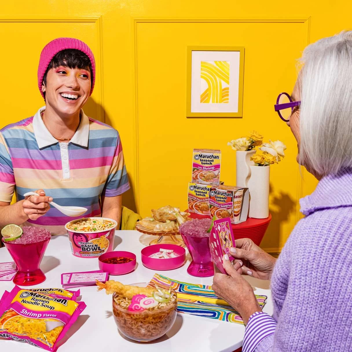 People sitting at a dinner table together and smiling