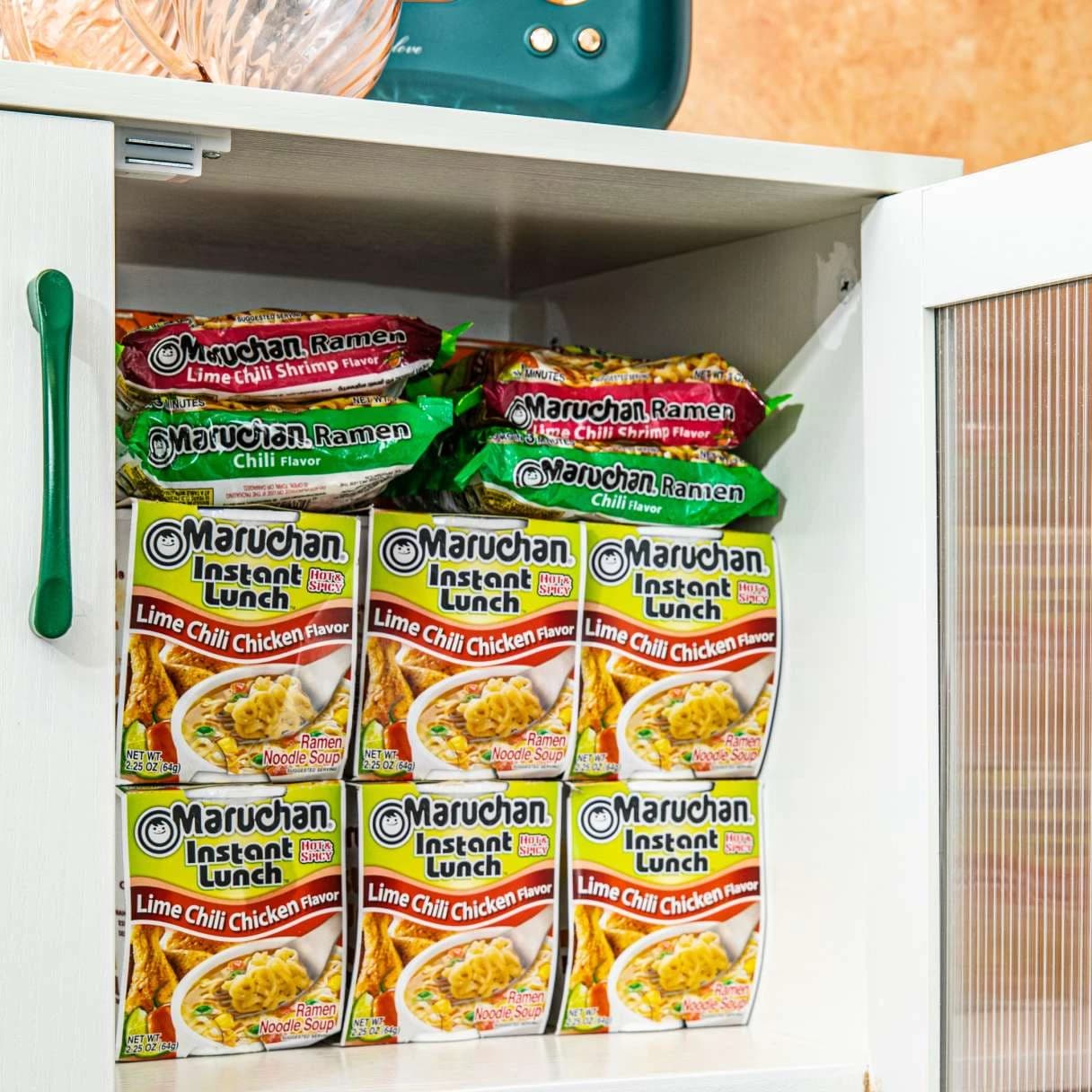 Packages of Maruchan ramen and instant lunch products in a cupboard