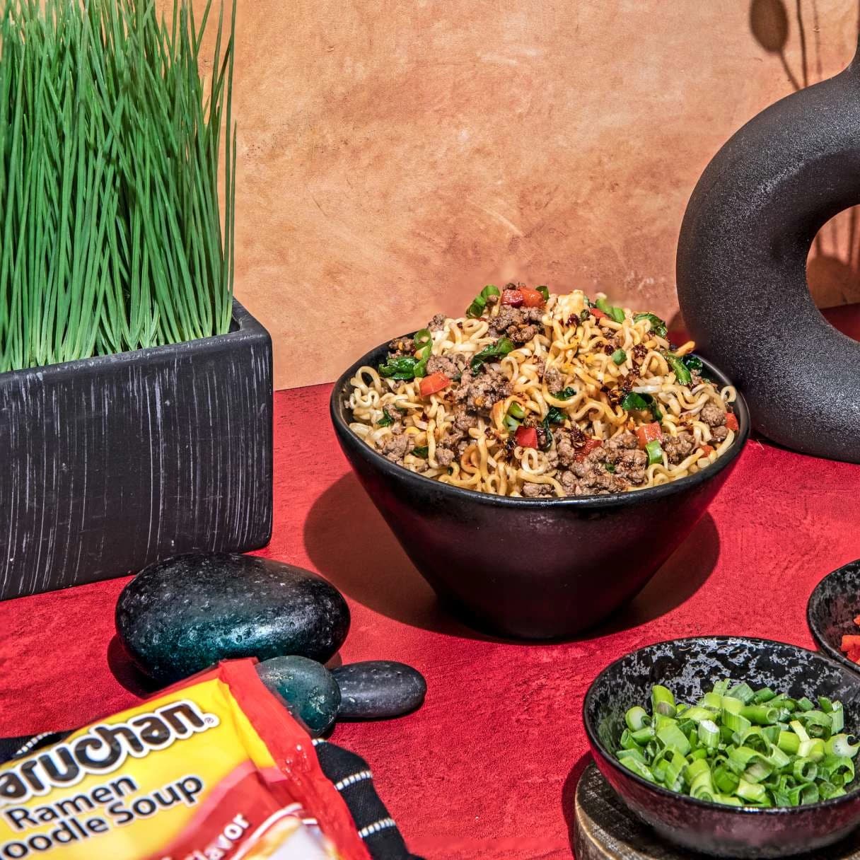 Bowl of ramen on a table with black decor pieces