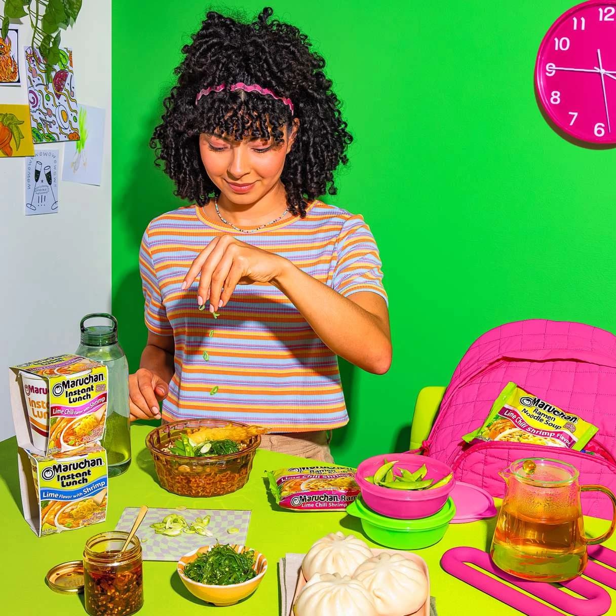 Woman eating ramen at a dining table