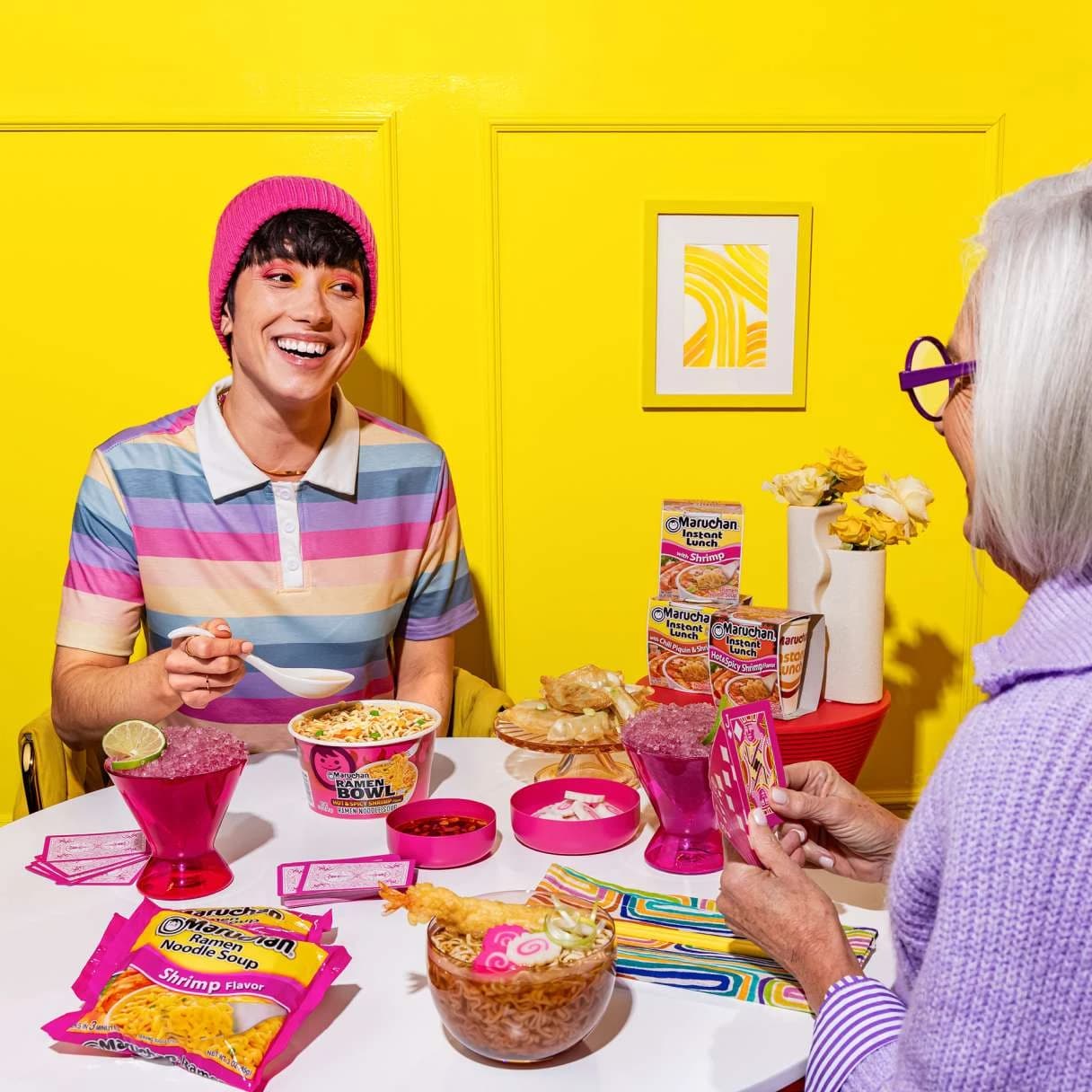 People smiling while eating maruchan ramen on a dining table
