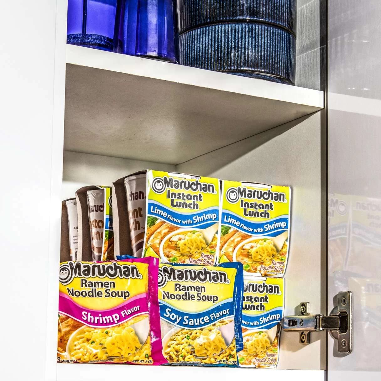 Ramen packages on a shelf in a cupboard
