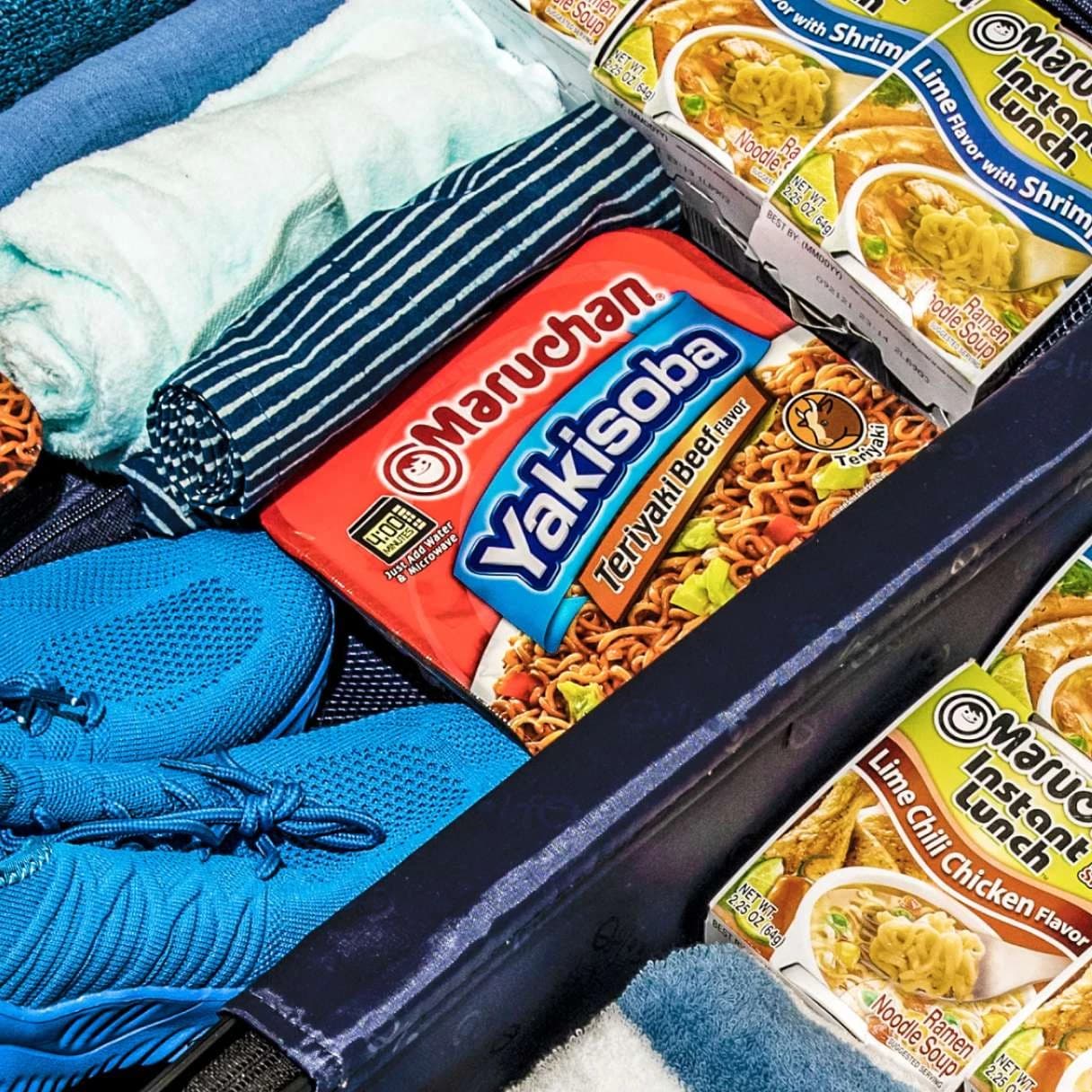 Packages of Maruchan products in a suitcase